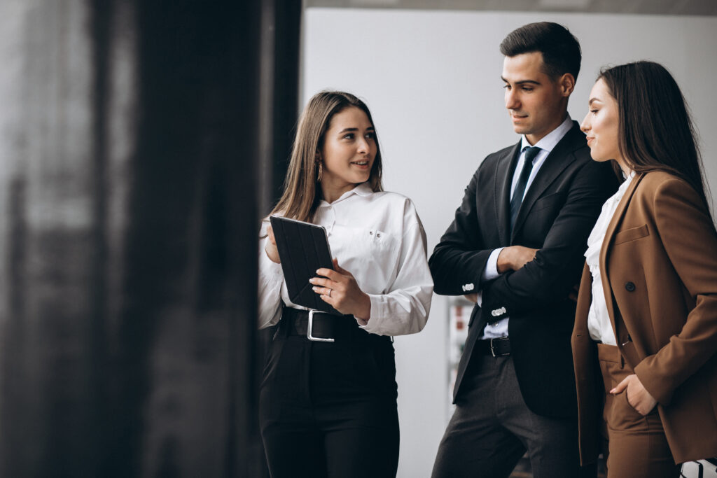 male and female business people working on tablet in office